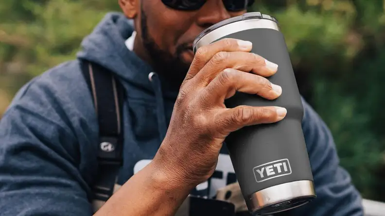 Man holding a Yeti tumbler