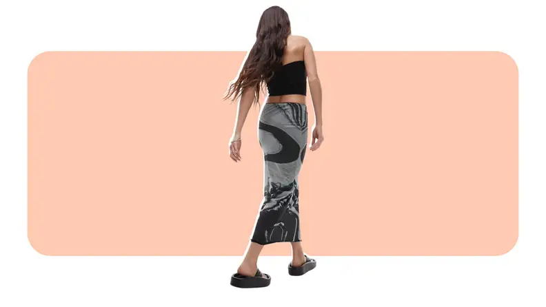 A model wearing a black and gray marble-print midi skirt.