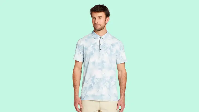 An image of a pale blue and white floral-patterned short-sleeve golf polo.