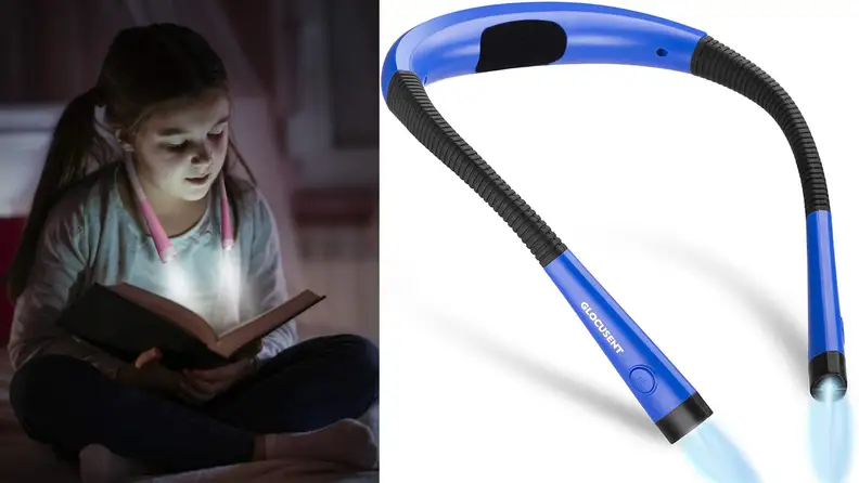 A child reads in the dark with a wearable reading lamp.