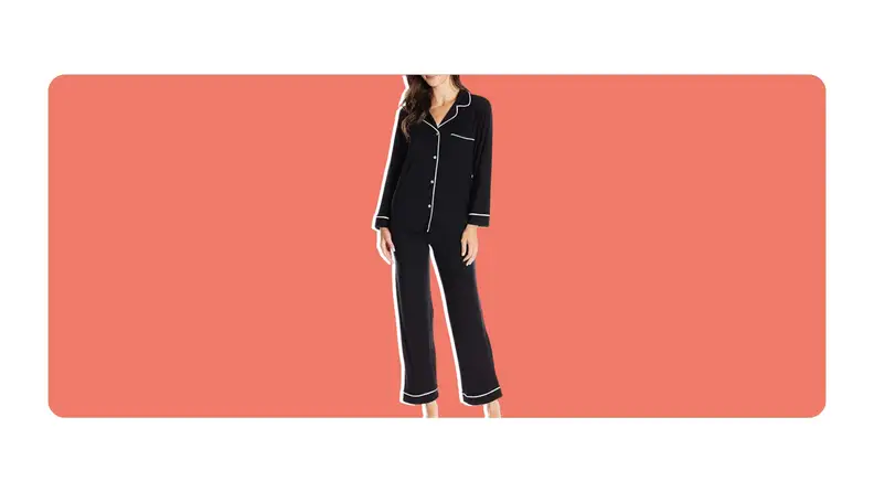 A model poses while wearing a black pair of Eberjey's Gisele Pajama Set.