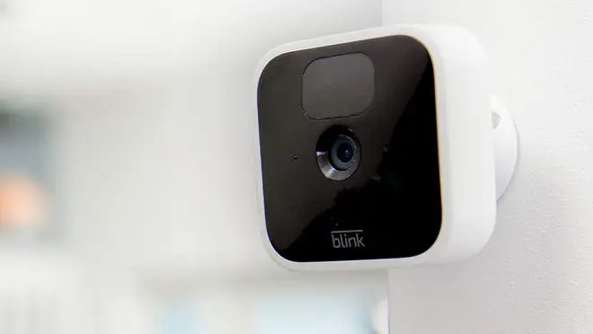 Blink home camera device mounted on wall.