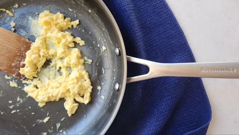 Top view of the pan being used to cook scrambled eggs.