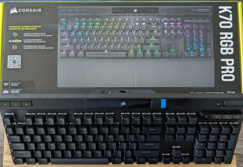 A keyboard standing up aganist its box
