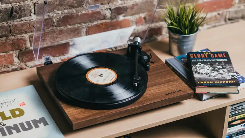 A record player on top of a credenza.