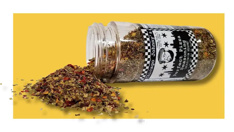 Open spice container spilling over on a yellow background