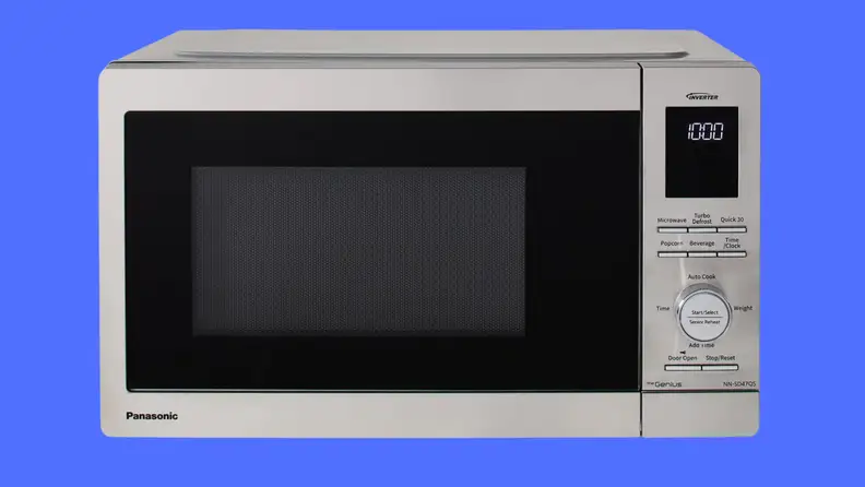 A black microwave on a blue background