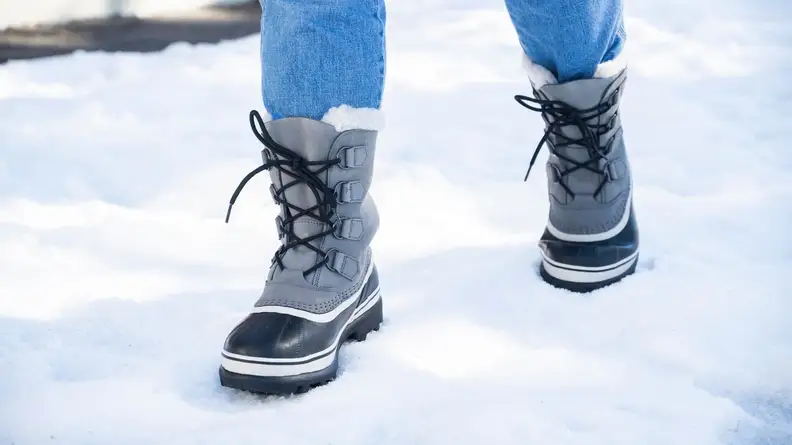 Girl walking in Sorel Women's Caribou Boots.