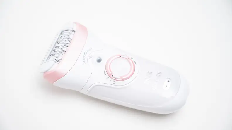 The Braun Silk-Epil 9 laying on a white background.