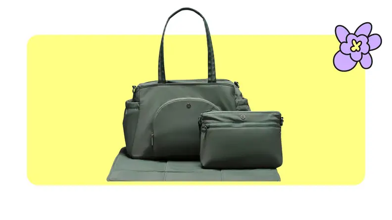 Product shot of the lululemon baby tote bag with smaller toiletry bag in front of it in Grey Eucalyptus/Trench color in front of a yellow background with a purple cartoon flower in the corner..