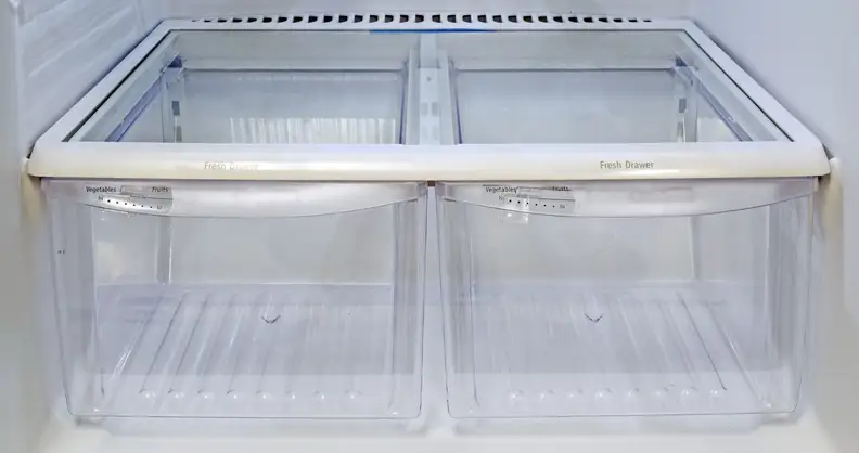 Two empty crisper drawers side by side on the bottom level of a fridge,