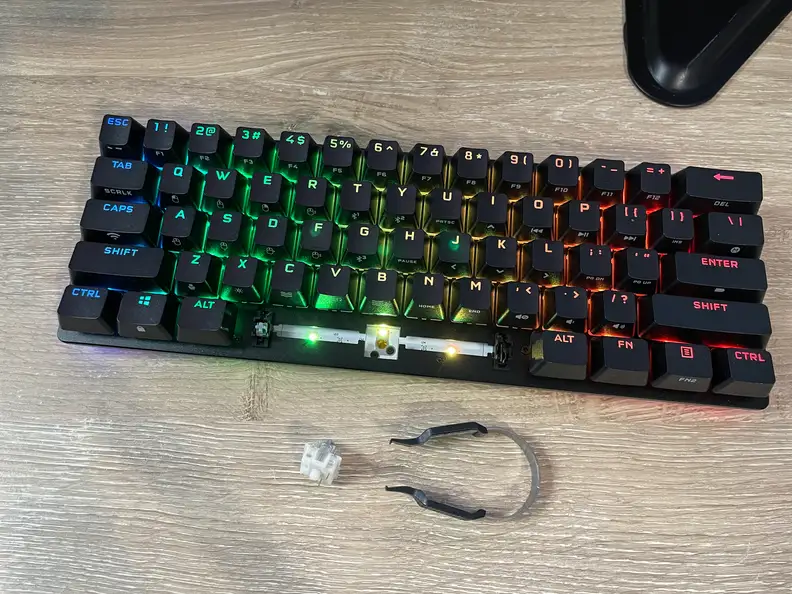 A small black keyboard with a mechanical key switch in front of it.