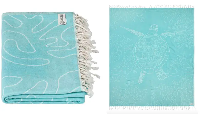 Light blue beach towel with a sea turtle print.