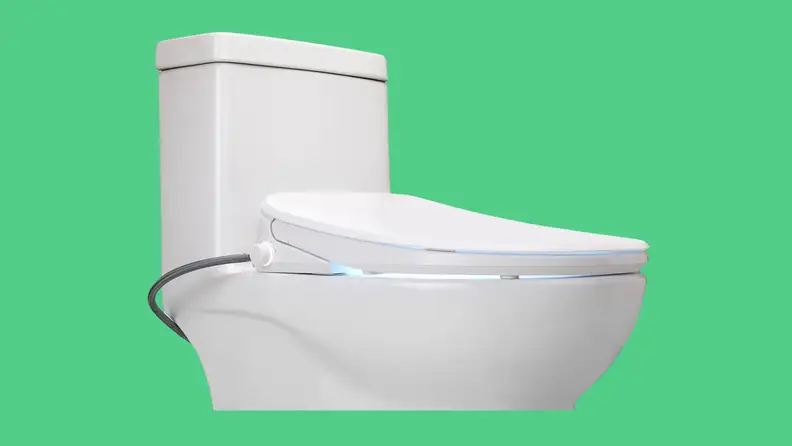 A bidet on a toilet appears on a green background.