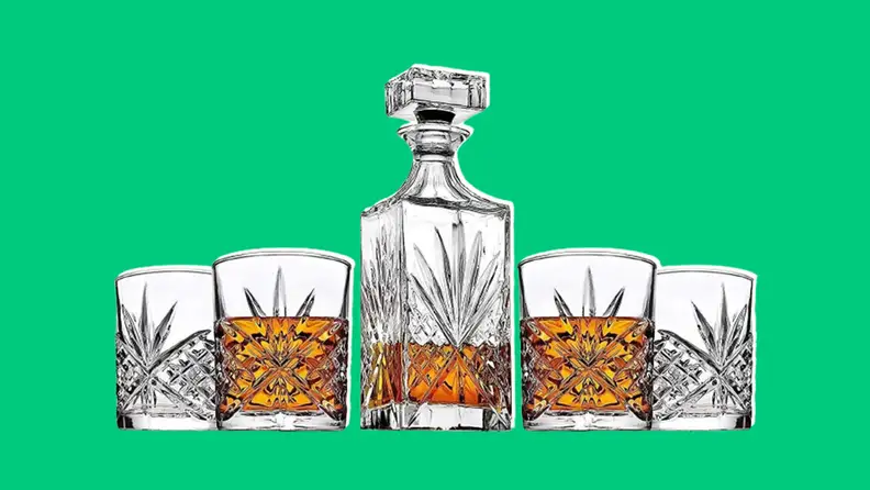 Whiskey decanter set on dark green background