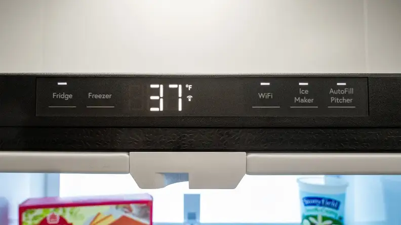 A close-up of the fridge's temperature display, centered along the top edge of the refrigerator compartment.