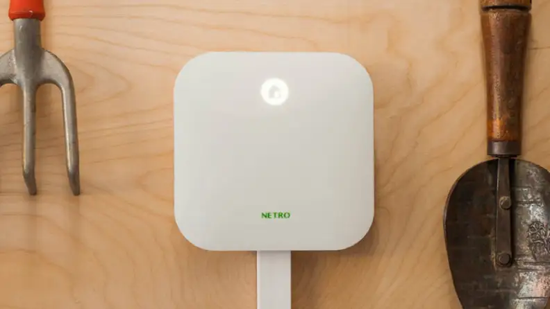 Netro Sprite Smart Sprinkler Controller mounted on plywood with tools