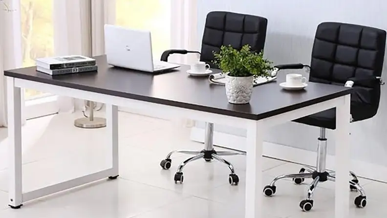 Modern home office with computer desk and desk chairs.