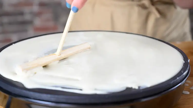 Make sure not to break the crepe while spreading it counterclockwise.