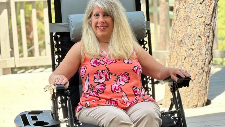 Person smiling while sitting in the Best Choice Products Oversized Padded Zero Gravity Chair with arms on both armrests.