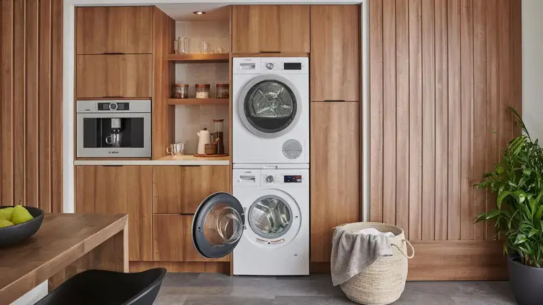 Modern washer and dryer set from Bosch in kitchen.