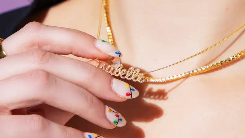 hand holding gold necklace
