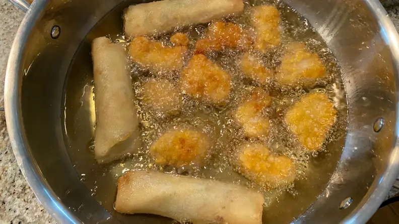 The Hestan Cue 5.5-Quart Chef's Pot is frying up some chicken tenders and egg rolls.
