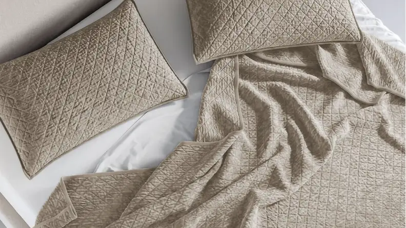 tan pillow and blanket on bed