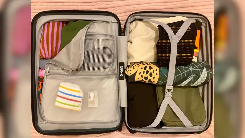 Interior of smaller Coolife suitcase with clothes packed inside.