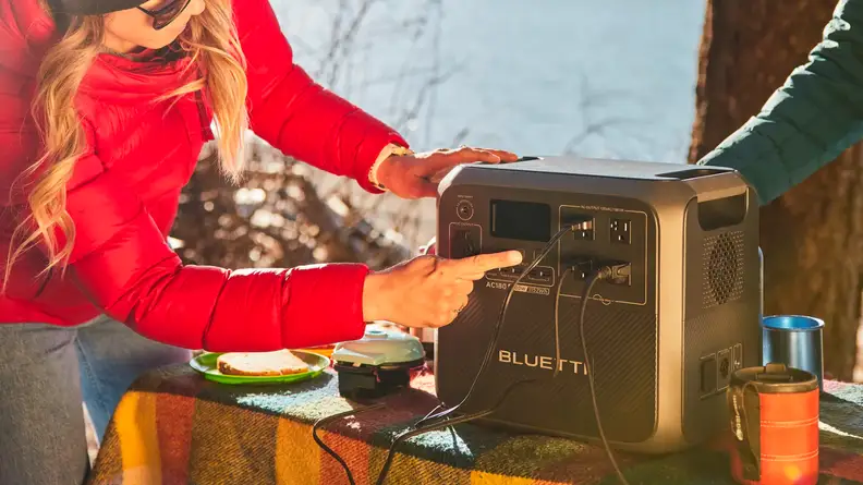 Woman plugging something into the Bluetti AC180