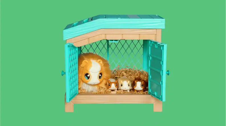A live pets set with a large animal next to three baby animals laying in a toy barn.