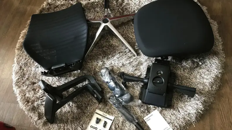 The Branch Ergonomic Chair disassembled on the floor