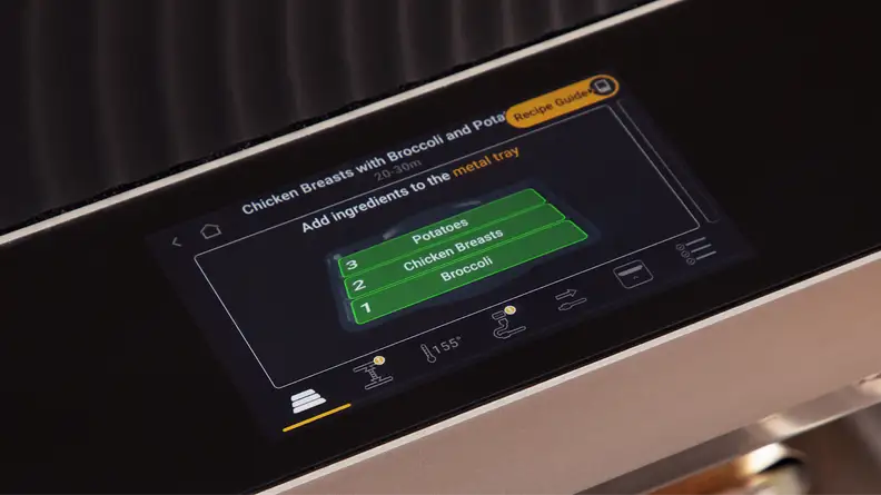 A closer view of the Brava Glass oven's touchscreen featuring different cooking zones for chicken breasts, broccoli and potatoes.