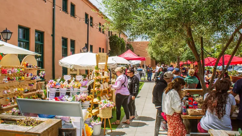 Outdoor vendor stalls at Liberty Public Market on a sunny day