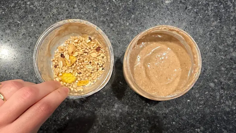 Two cups of smoothie on a countertop.