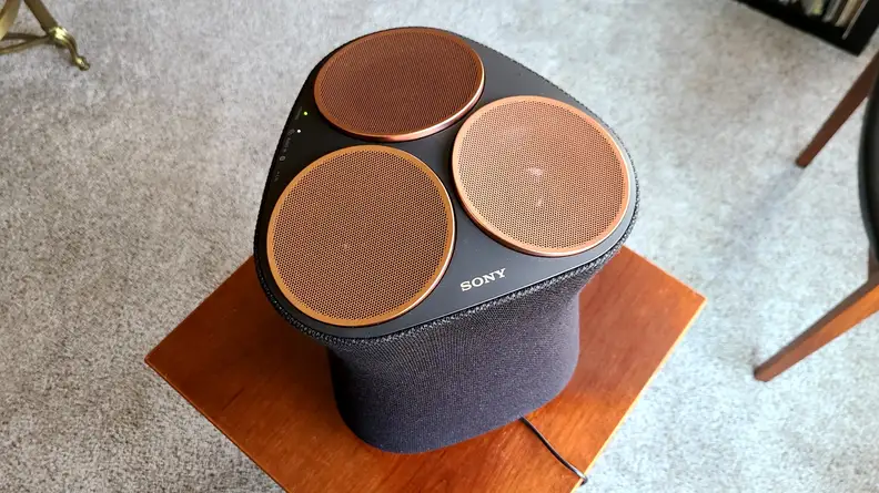 Sony SRS-RA5000 shown from the top copper drivers on a wooden end table