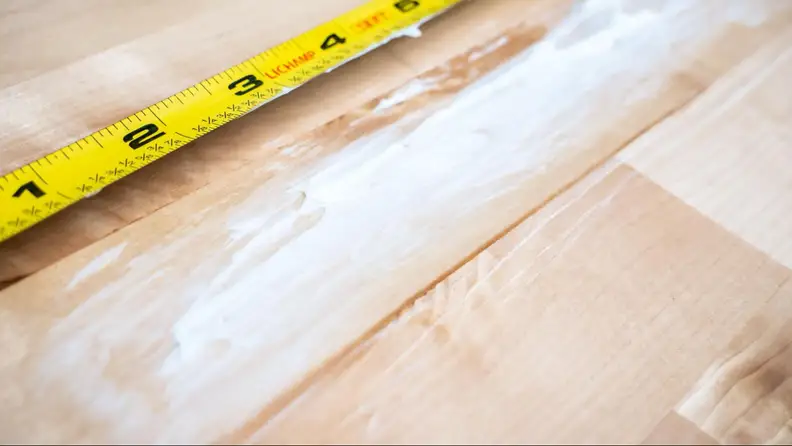 Butter smeared on a wooden countertop.