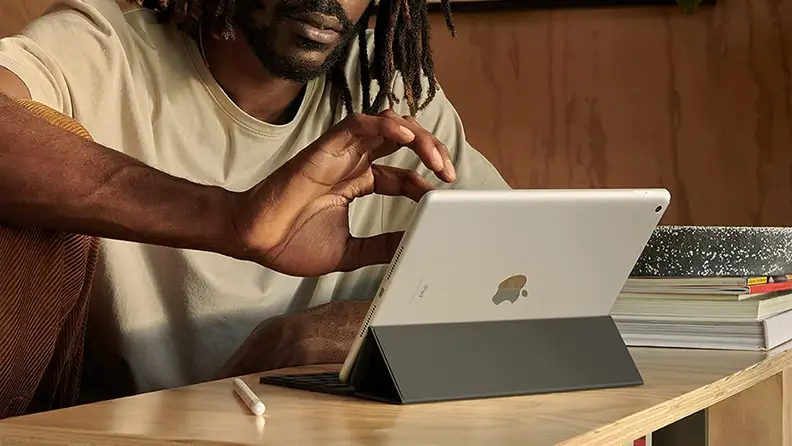 A man browsing on an iPad in landscape.