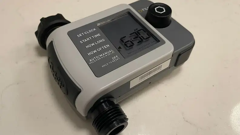 The  B-hyve Smart Hose Faucet Timer (second-gen) on a kitchen counter