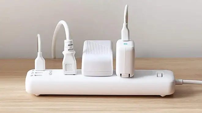 White power strip with plugs sticking out of it.
