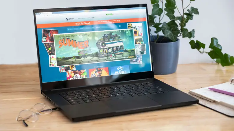 A frontal shot of the laptop, showing glare on the screen.