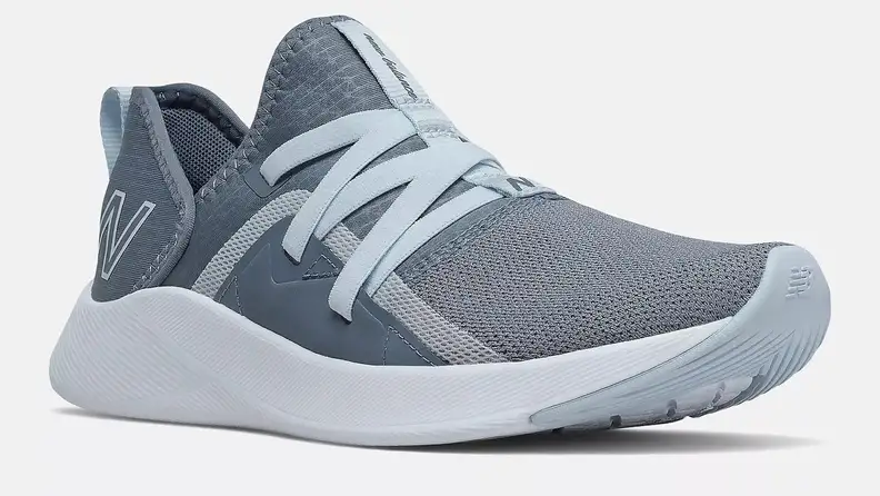 A gray and blue New Balance Beaya shoe against a white background.