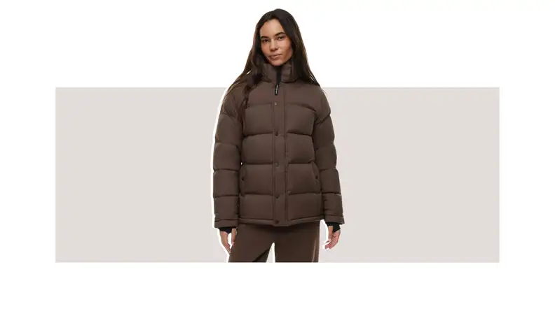 A model wearing a brown puffer coat.