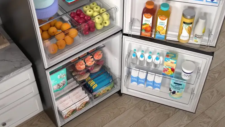 Open refrigerator stocked with food, drinks, and dairy products.