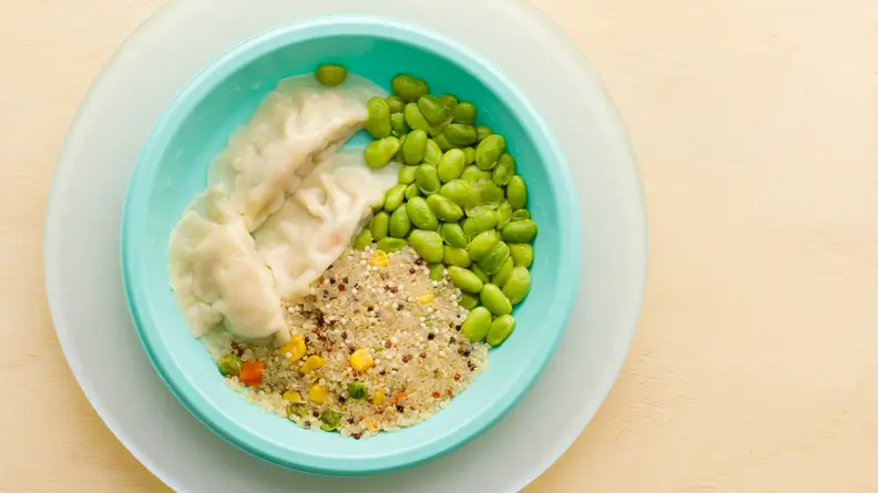 Plate of potstickers, edamame, and quinoa