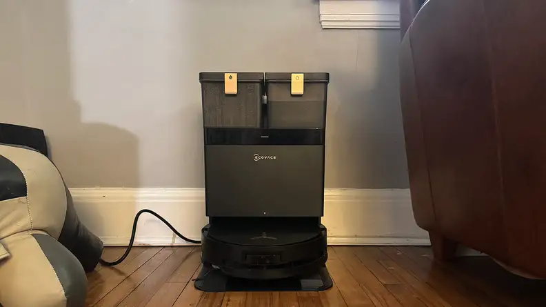 A black robot vacuum at its dock station