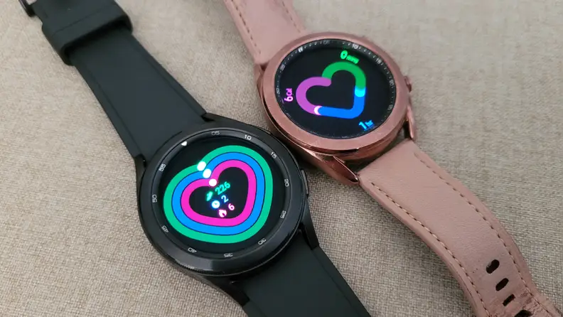 The Galaxy Watch 4 next to the Galaxy Watch 3, showing their fitness dashboard interfaces.