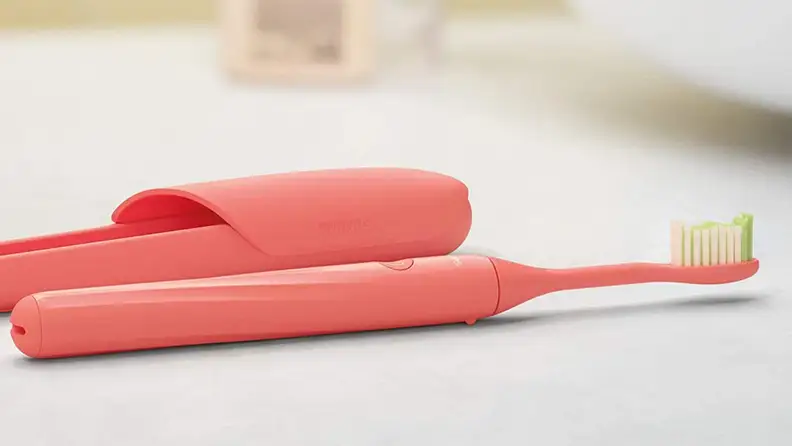 Close up of a pink toothbrush.