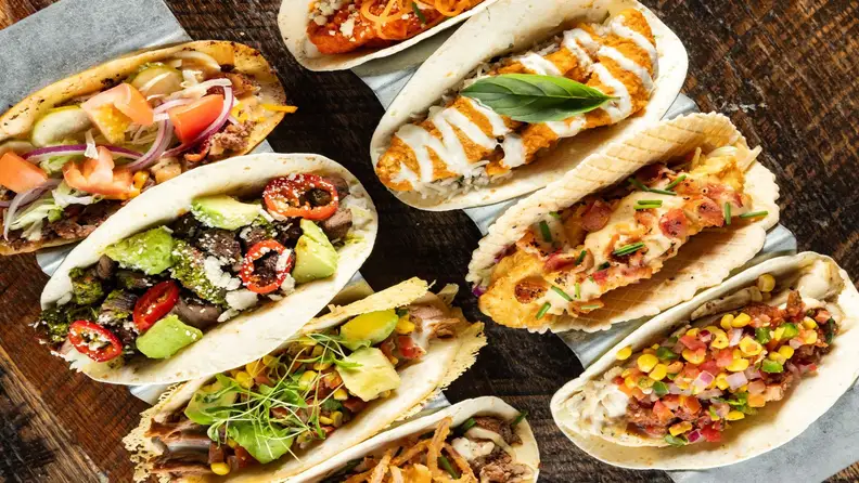 An overhead spread of assorted gourmet tacos