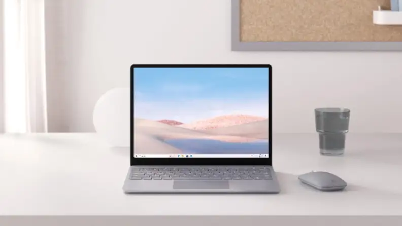 A laptop sits on a minimalistic desk.